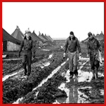 [Photo] Crewmen from the 485th Bombardment Group avoid the deep ruts in the mud.