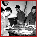 [Photo] 381st Bomb Group members at work in the photographic lab.